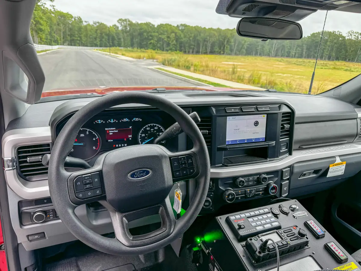 Center console close-up showing radios, switches, and cup holders.
